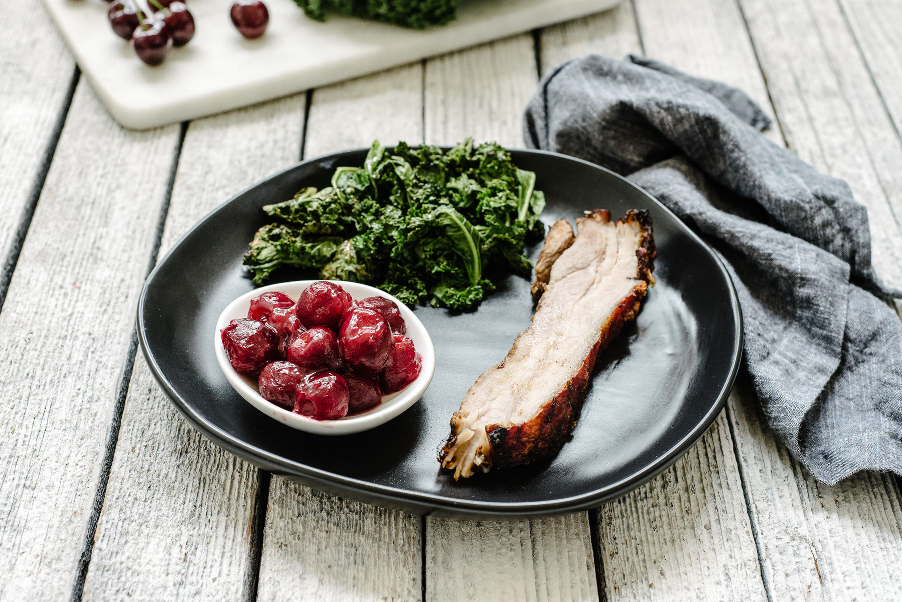 Pork belly with cherry sauce & kale